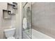 Bathroom with a shower-tub combo, tiled walls, and modern toilet at 6832 Apogee Ridge Ct, Las Vegas, NV 89135