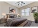 Bedroom with a large bed, stylish decor, a ceiling fan, and a large window at 6832 Apogee Ridge Ct, Las Vegas, NV 89135