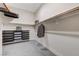 Walk-in closet with shelves, racks, drawers, and seating at 6832 Apogee Ridge Ct, Las Vegas, NV 89135