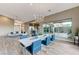 Bright dining room with modern chandelier, sleek dining table, and large window with backyard view at 6832 Apogee Ridge Ct, Las Vegas, NV 89135