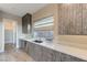 Kitchen with custom cabinetry, stainless steel appliances, and a bright window at 6832 Apogee Ridge Ct, Las Vegas, NV 89135