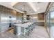 Kitchen boasts stainless steel appliances, a large island, and custom wood cabinets at 6832 Apogee Ridge Ct, Las Vegas, NV 89135