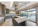 Kitchen with marble island, wooden cabinets, and stainless appliances, offering outdoor access at 6832 Apogee Ridge Ct, Las Vegas, NV 89135