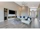 Bright living room features a fireplace, built-in shelving, and a white sectional at 6832 Apogee Ridge Ct, Las Vegas, NV 89135