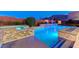 Backyard with sparkling pool and spa featuring modern stonework and a cozy, manicured garden at 6832 Apogee Ridge Ct, Las Vegas, NV 89135