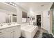 Bright bathroom features a soaking tub, double sinks and walk-in shower at 7344 Jelson Falls St, Las Vegas, NV 89131