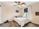 Cozy bedroom with ceiling fan, large window and carpeted floor at 7344 Jelson Falls St, Las Vegas, NV 89131