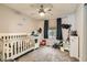 Bright Bedroom with crib, ceiling fan and carpeted floors at 7344 Jelson Falls St, Las Vegas, NV 89131