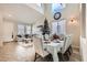 Open-concept dining area connected to the living room features high ceilings and large windows at 7344 Jelson Falls St, Las Vegas, NV 89131