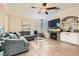 Cozy living room features a fireplace, ceiling fan, and tile flooring, creating an inviting atmosphere at 7344 Jelson Falls St, Las Vegas, NV 89131