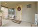 Inviting front porch featuring comfortable seating and a decorative wreath on the decorative security door at 7344 Jelson Falls St, Las Vegas, NV 89131