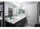 Bathroom featuring a double sink vanity and well-lit mirror at 7485 Rainbow Spray Dr, Las Vegas, NV 89131