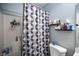 Modern bathroom with a shower-tub combination featuring a decorative gray and white shower curtain at 7485 Rainbow Spray Dr, Las Vegas, NV 89131