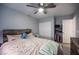 Cozy bedroom featuring a wood-framed bed, ceiling fan, and closet with some items visible at 7485 Rainbow Spray Dr, Las Vegas, NV 89131