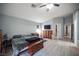 Expansive bedroom featuring wood-look flooring, a ceiling fan, and classic wooden furniture at 7485 Rainbow Spray Dr, Las Vegas, NV 89131