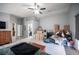 Large bedroom featuring wood-look flooring, ceiling fan, and sitting area by a window at 7485 Rainbow Spray Dr, Las Vegas, NV 89131