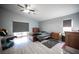 Spacious bedroom with wood-look flooring, ceiling fan and multiple dressers providing ample storage space at 7485 Rainbow Spray Dr, Las Vegas, NV 89131