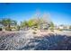 Beautiful community park with rock feature and landscaping, lush trees, gazebo, and walking paths at 7485 Rainbow Spray Dr, Las Vegas, NV 89131