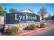 Elegant community entrance sign displaying community name with stone base and manicured landscaping at 7485 Rainbow Spray Dr, Las Vegas, NV 89131