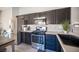 Close-up of kitchen featuring stainless steel appliances, black cabinetry, and modern sink at 7485 Rainbow Spray Dr, Las Vegas, NV 89131