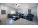 Cozy living room with gray sofas, wood-look floors and a ceiling fan for added comfort at 7485 Rainbow Spray Dr, Las Vegas, NV 89131