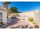 Large backyard featuring rock landscaping, block wall, and mature trees at 7608 Little Valley Ave, Las Vegas, NV 89147