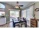 Charming dining area with a sliding glass door and a modern ceiling fan at 7608 Little Valley Ave, Las Vegas, NV 89147