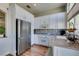 Modern kitchen with stainless steel refrigerator and white cabinets at 7608 Little Valley Ave, Las Vegas, NV 89147