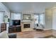 Warm living room with fireplace, hardwood floors, and a bright window at 7608 Little Valley Ave, Las Vegas, NV 89147