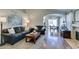 Inviting living room featuring hardwood floors, a cozy fireplace, and an open view to the dining area at 7608 Little Valley Ave, Las Vegas, NV 89147