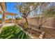 Nice backyard features include artificial turf, desert landscaping and covered patio with pergola at 7928 Broadwing Dr, North Las Vegas, NV 89084