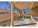 Shaded backyard with pergola-covered patio, desert landscaping, and a serene, private setting at 7928 Broadwing Dr, North Las Vegas, NV 89084