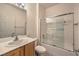 Bright bathroom featuring a shower/tub combo with glass doors and a vanity with sink at 7928 Broadwing Dr, North Las Vegas, NV 89084