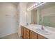 Bathroom featuring a double sink vanity, a shower, and a well-lit mirror at 7928 Broadwing Dr, North Las Vegas, NV 89084