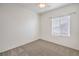 This bedroom features neutral carpet, a window with blinds, and base trim at 7928 Broadwing Dr, North Las Vegas, NV 89084