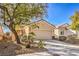 The front exterior of this home features desert landscaping and an attached two car garage at 7928 Broadwing Dr, North Las Vegas, NV 89084