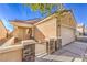 The exterior of this single-story home features desert landscaping, a two car garage, and a gated front porch at 7928 Broadwing Dr, North Las Vegas, NV 89084