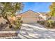 Charming single-story home with desert landscaping, long driveway and an attached two car garage at 7928 Broadwing Dr, North Las Vegas, NV 89084