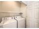 A dedicated laundry room with a washer, dryer, and storage shelf at 7928 Broadwing Dr, North Las Vegas, NV 89084