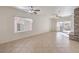 Bright living room with large windows, tile floors, and sliding doors to the backyard patio at 7928 Broadwing Dr, North Las Vegas, NV 89084