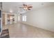 Spacious living room featuring tile flooring, ceiling fans, and a view into the kitchen at 7928 Broadwing Dr, North Las Vegas, NV 89084