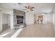 Open concept living room features a stone wall with built-in shelving and tile flooring at 7928 Broadwing Dr, North Las Vegas, NV 89084