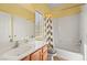 Bathroom featuring a shower-tub combo with a window and a single sink vanity at 8106 Buffalo Clan Ct, Las Vegas, NV 89131