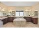 Luxurious bathroom with dual sinks, soaking tub and tile flooring and mirrors at 8106 Buffalo Clan Ct, Las Vegas, NV 89131