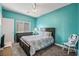 Charming bedroom with bright teal walls, plush carpet, and comfortable bedding at 8106 Buffalo Clan Ct, Las Vegas, NV 89131