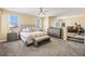 Spacious main bedroom featuring a king-size bed, a seating area and an ensuite bath at 8106 Buffalo Clan Ct, Las Vegas, NV 89131