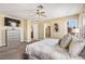 Relaxing bedroom with comfortable bedding, a ceiling fan, and a view to the outside at 8106 Buffalo Clan Ct, Las Vegas, NV 89131