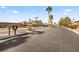 Well-maintained gated community entrance with palm trees and manicured landscaping at 8106 Buffalo Clan Ct, Las Vegas, NV 89131