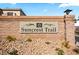 Elegant community entrance sign with stone accents and attractive desert landscaping at 8106 Buffalo Clan Ct, Las Vegas, NV 89131