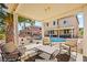 Relaxing covered patio with outdoor seating overlooks a pristine pool and lush backyard oasis at 8106 Buffalo Clan Ct, Las Vegas, NV 89131